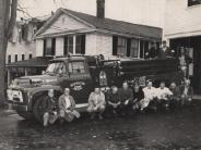 people in front of an old fire truck