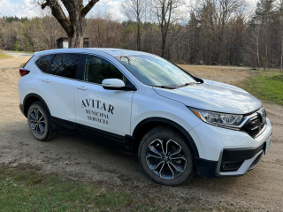 white sport utility vehicle marked with letters Avitar Assessing